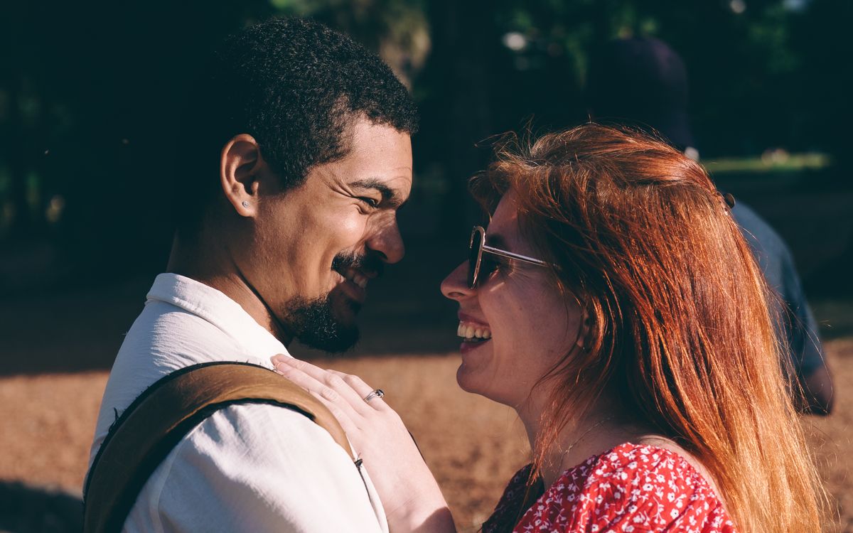 A couple sharing a smile outdoors